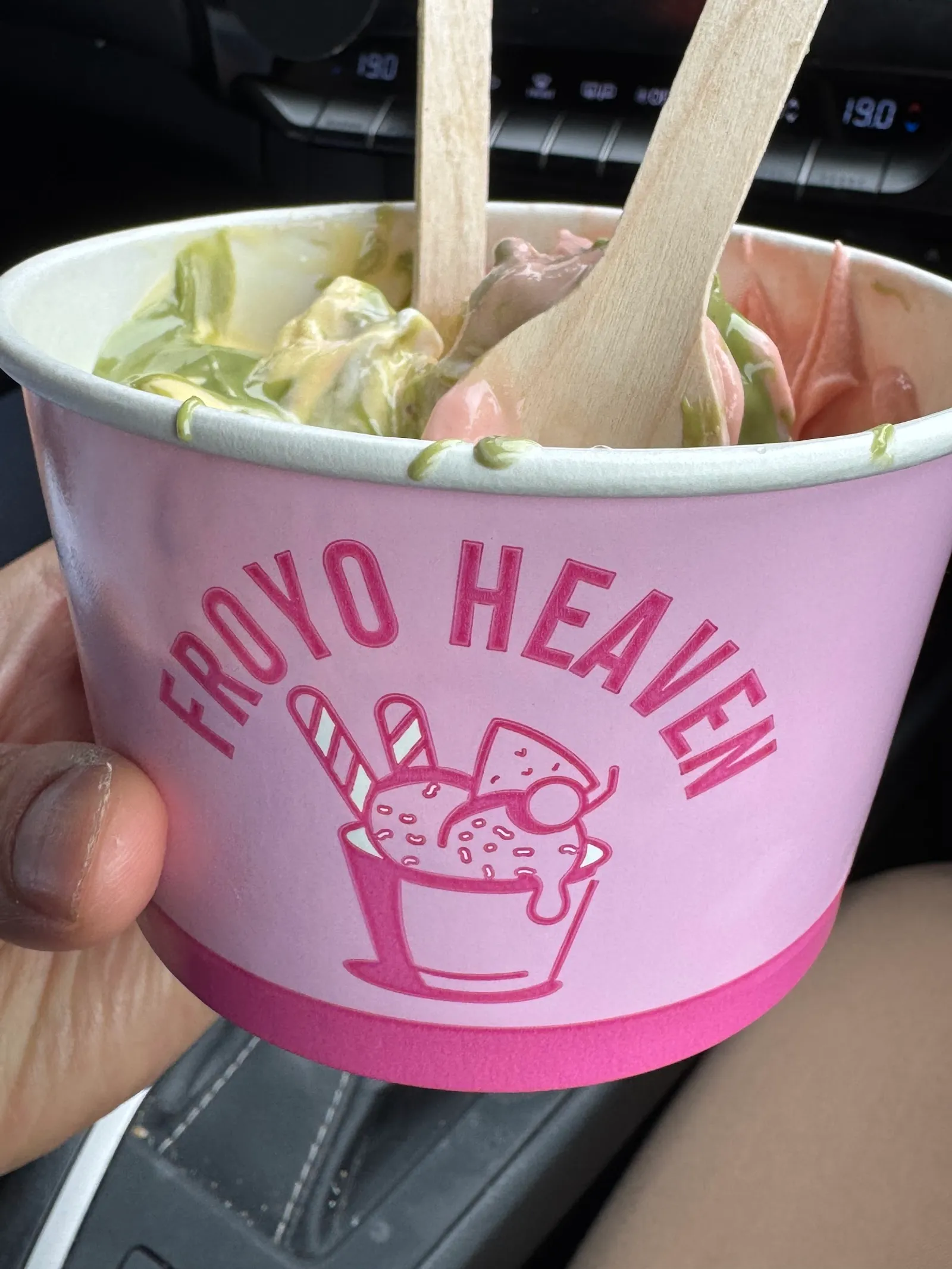 Froyo Heaven branded cup with multi-flavour swirl of matcha and pink froyo